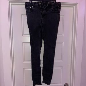 Worn black skinny jeans.